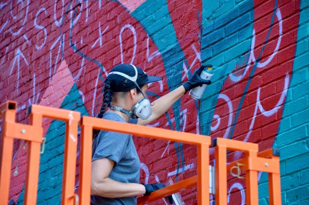 Muralist Sophy Tuttle working in downtown Hagerstown