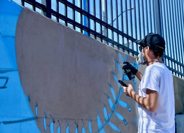Damien Mitchell creating mural at Meritus Park in downtown Hagerstown